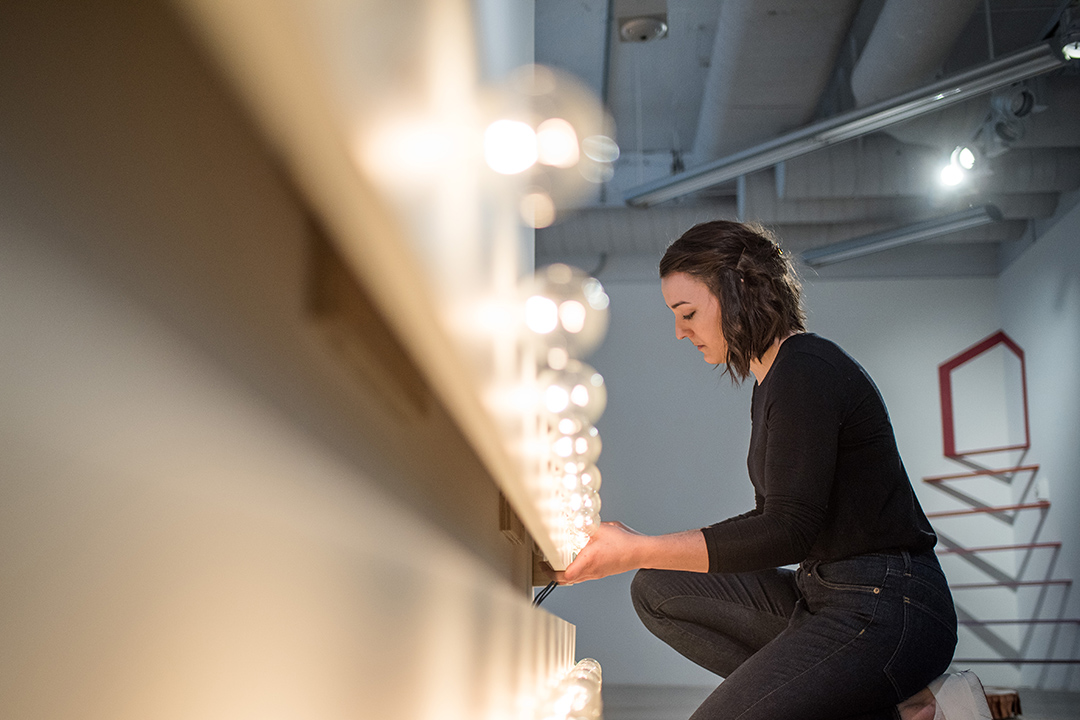 A student examines working in a museum gallery