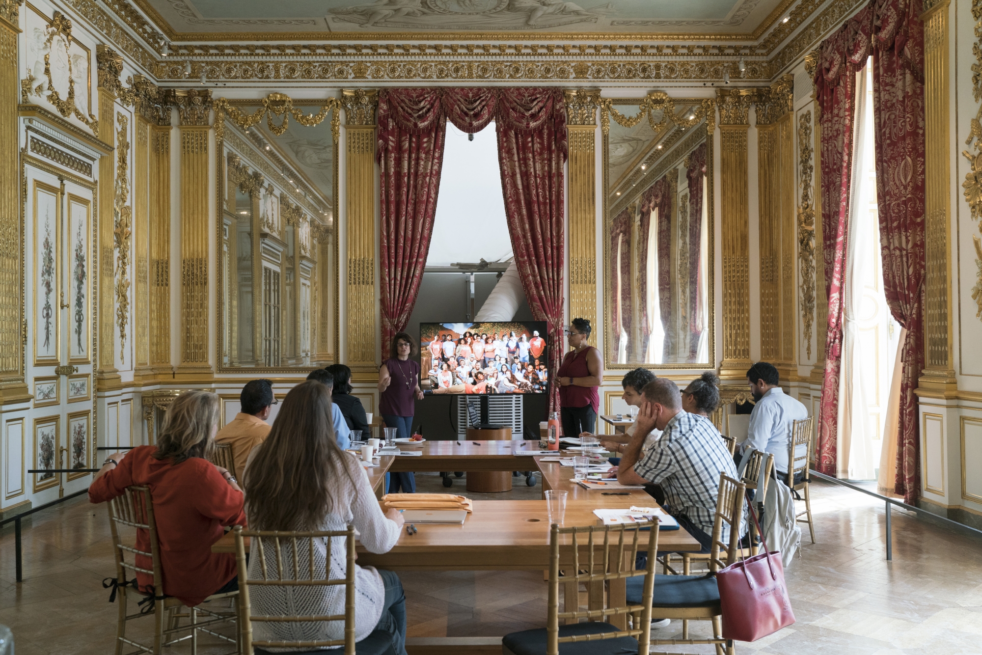 Female professors talking to room of students