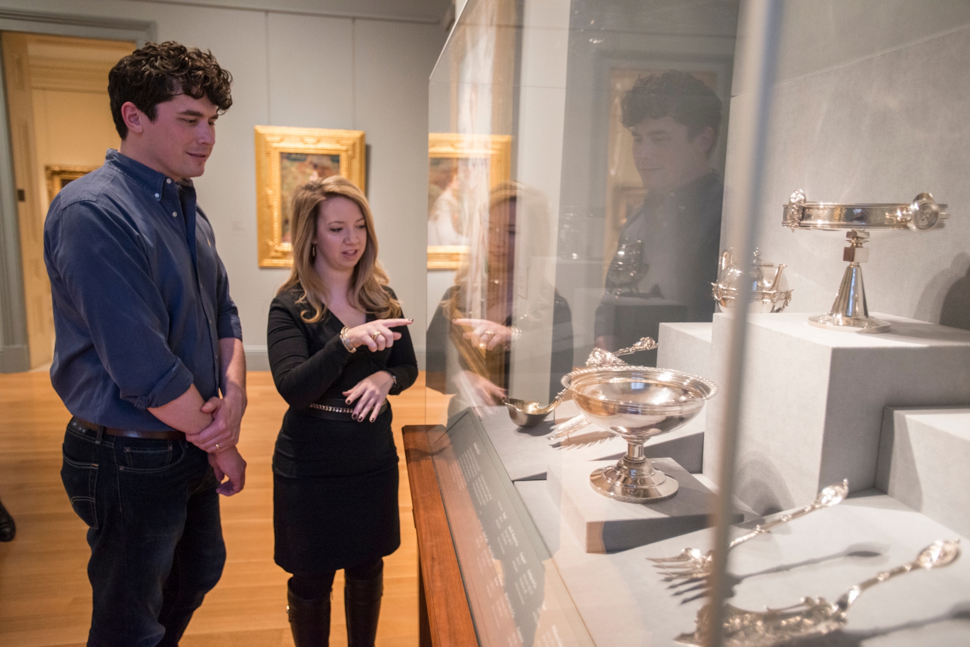 Male and female student looking at museum exhibit