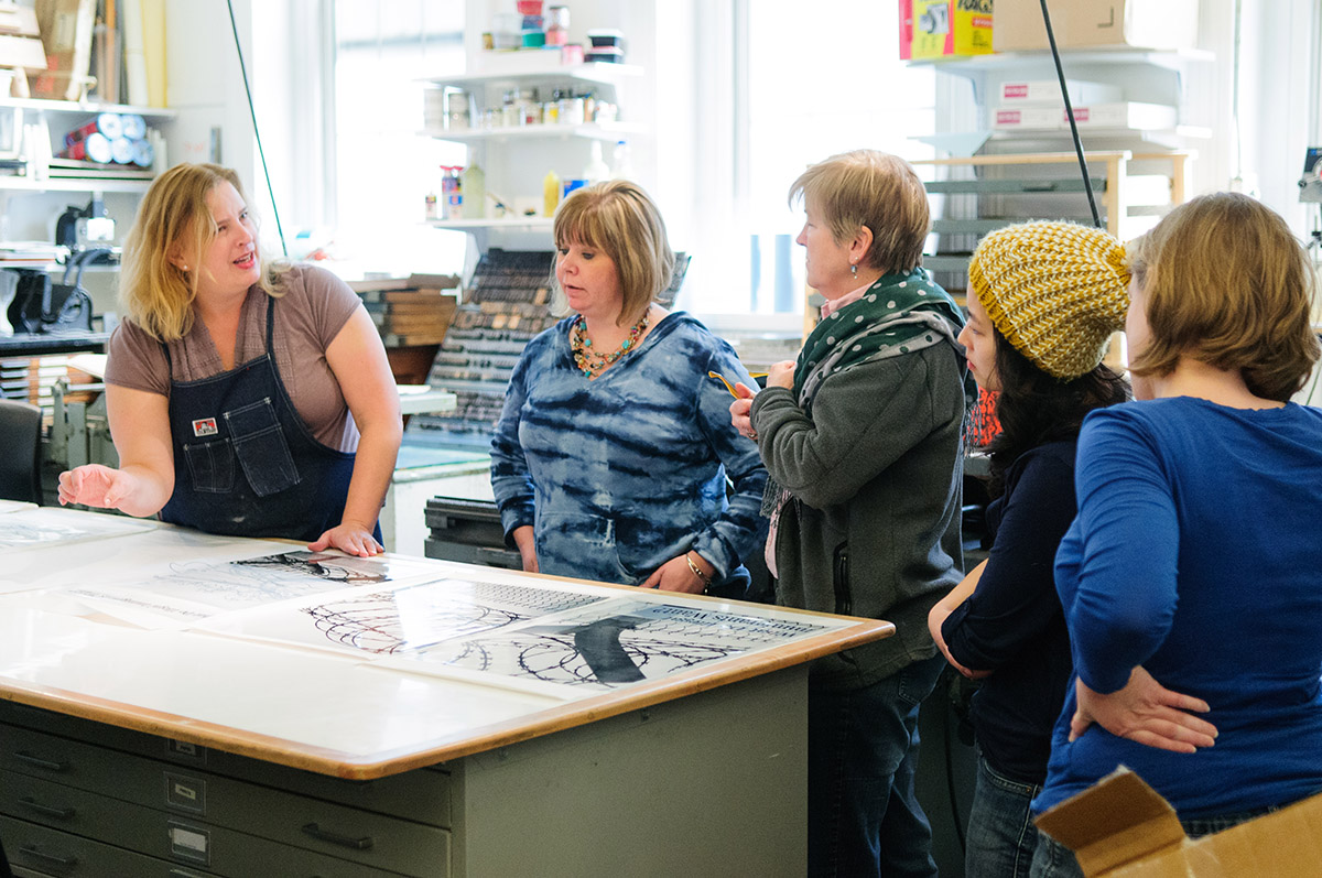 A Corcoran faculty member works with several students