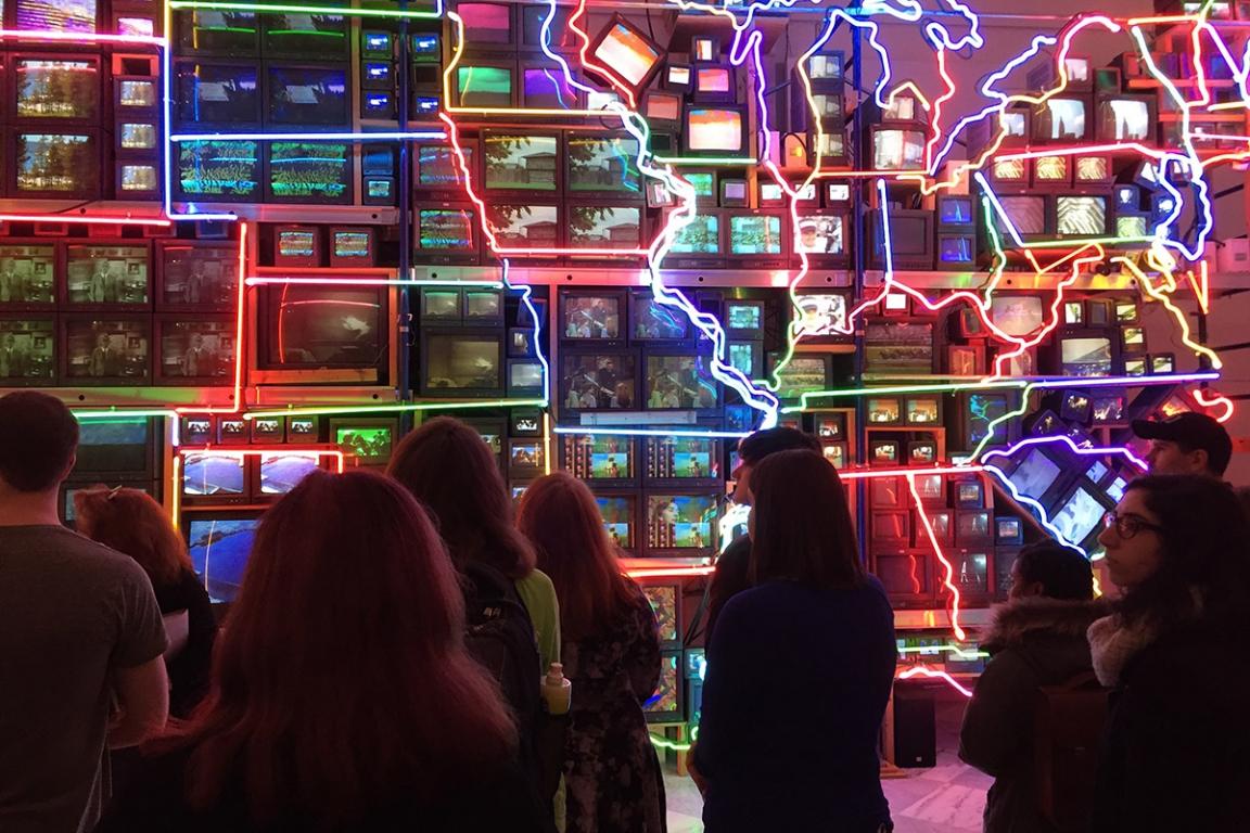 GW students in front of Nam June Paik's sculpture "Electronic Superhighway"